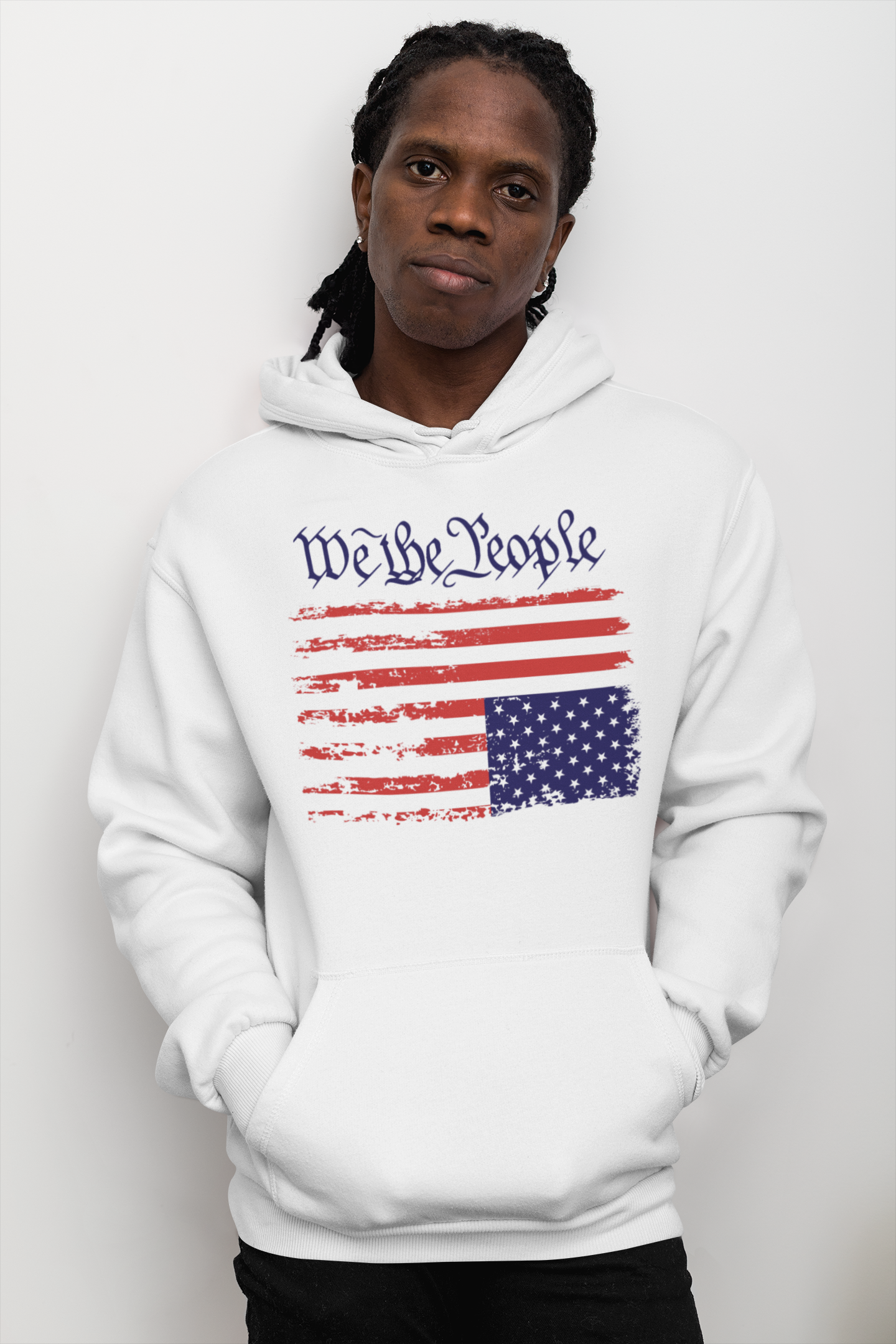a African American man wearing a We The People hoodie with a graphic design of a flag upside down that represents a distress signal