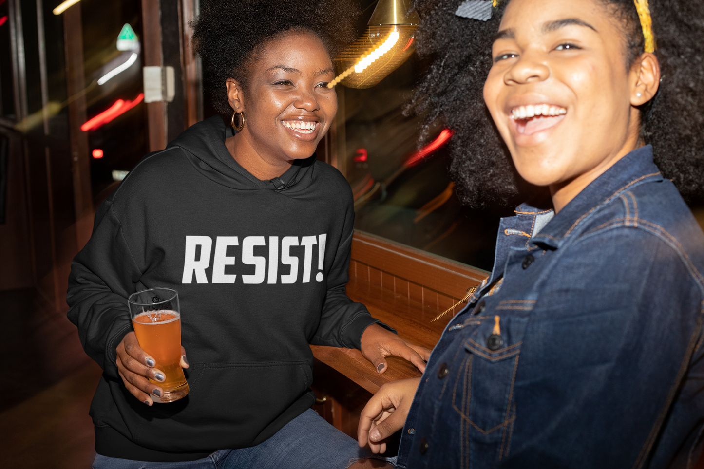 Ladies after a protest wearing "RESIST!" t-shirts and hoodies.